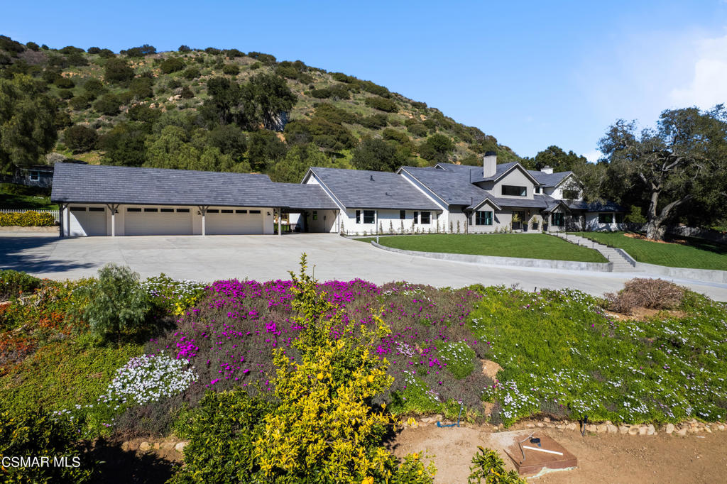 a view of a house with a big yard and potted plants