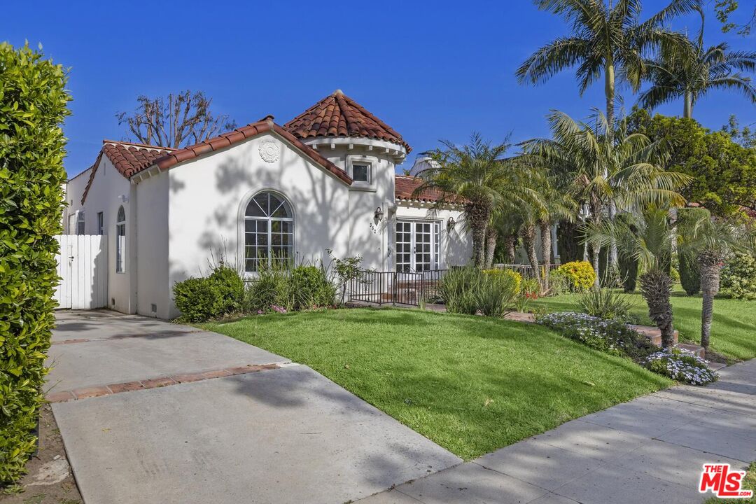 a front view of a house with a garden