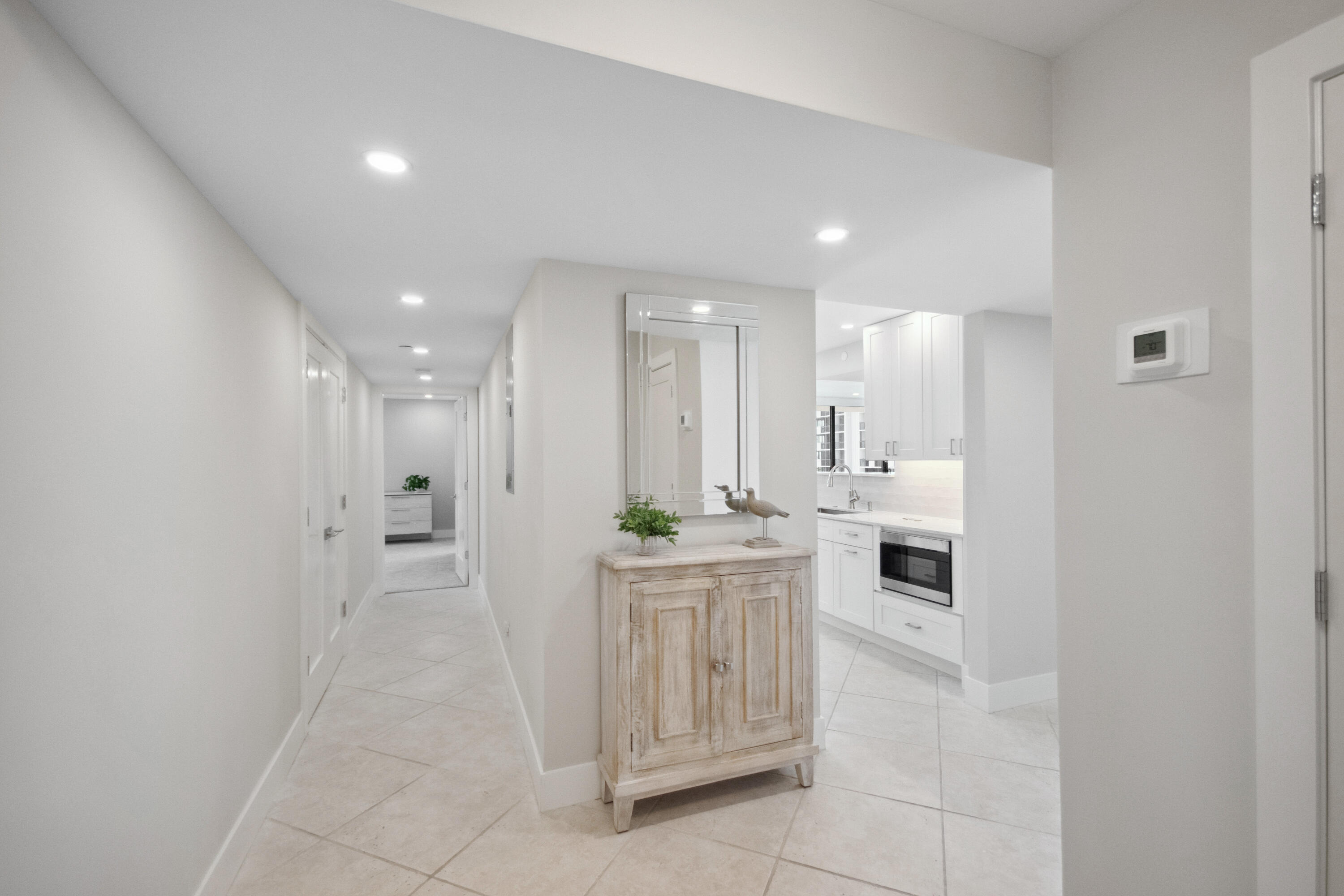 a kitchen with white cabinets and white appliances