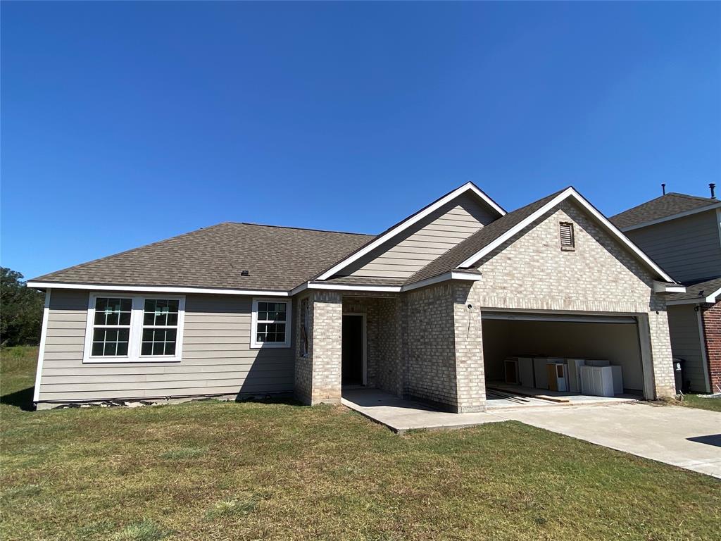 a front view of a house with yard and garage