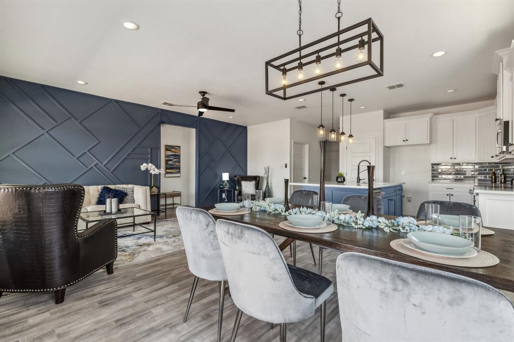 a kitchen with stainless steel appliances kitchen island granite countertop a sink and chairs