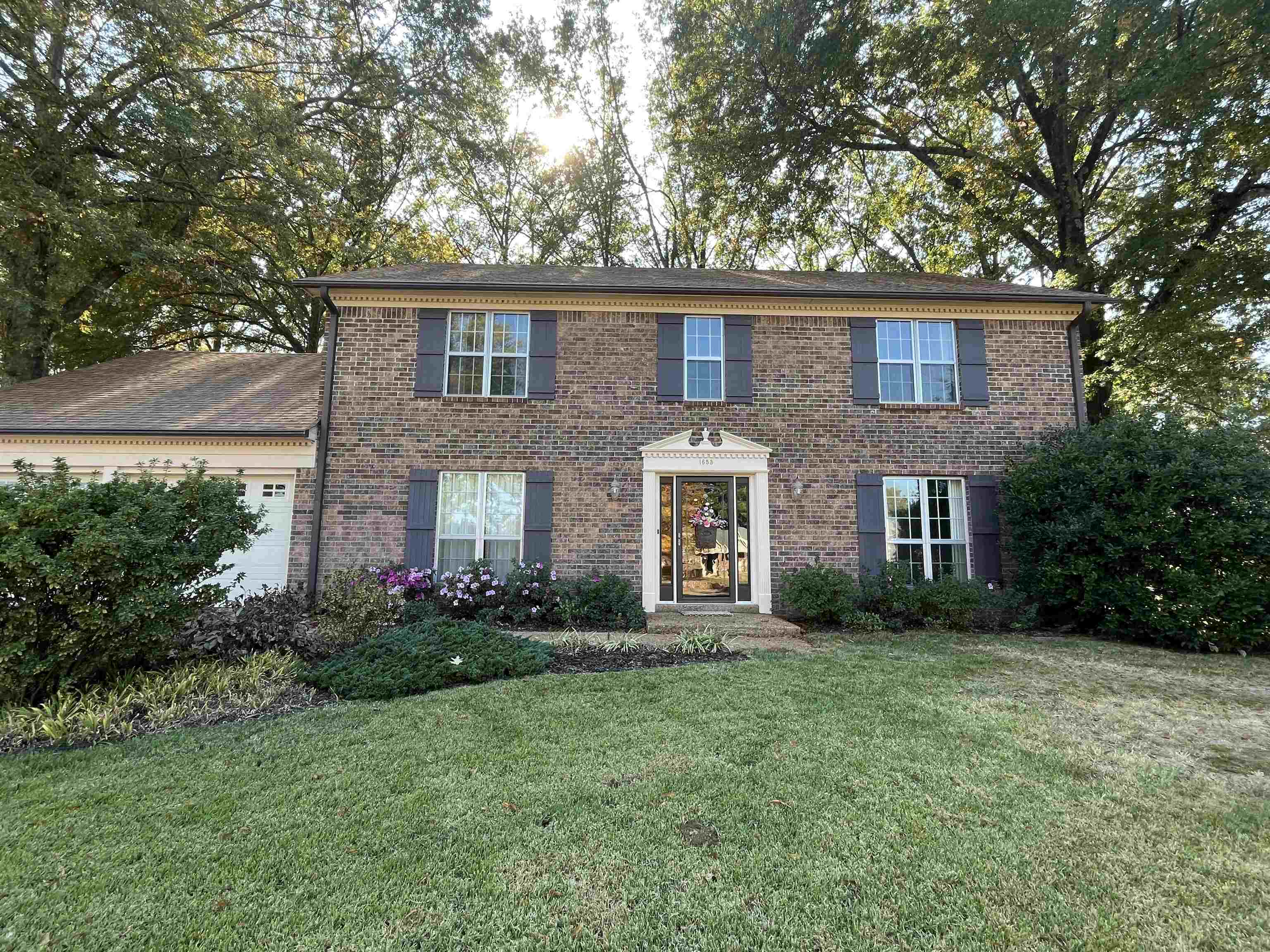 a front view of a house with garden