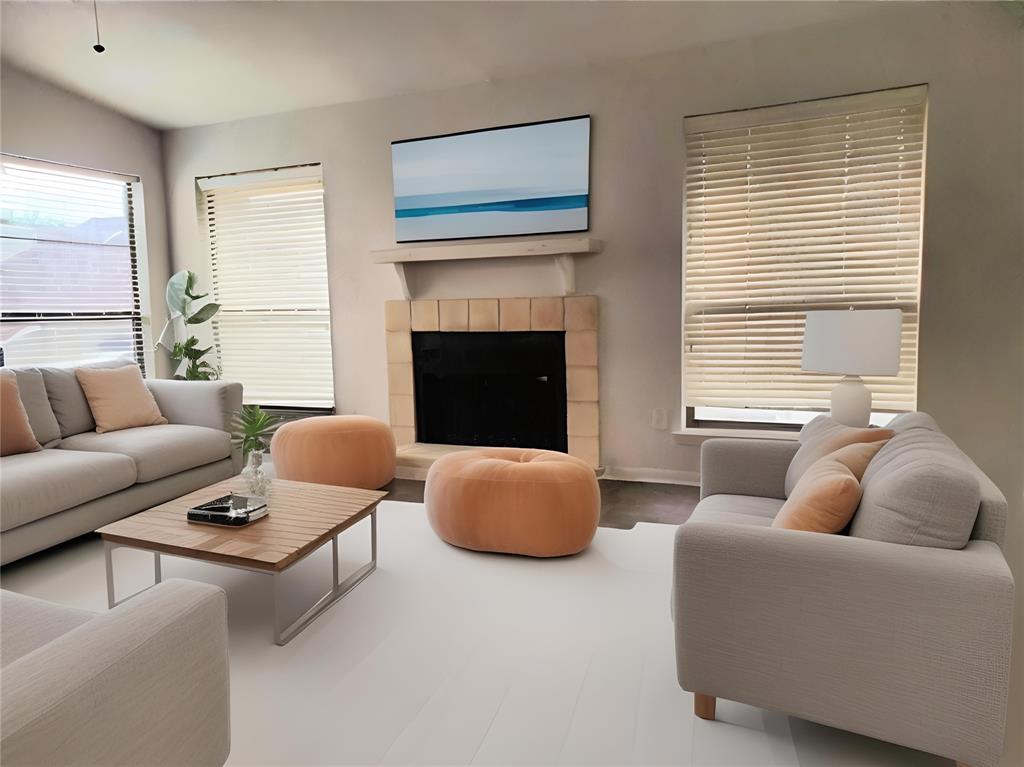 a living room with furniture a fireplace and window