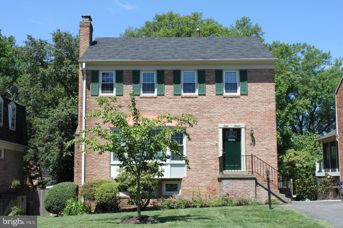 a house that has a tree in front of the house