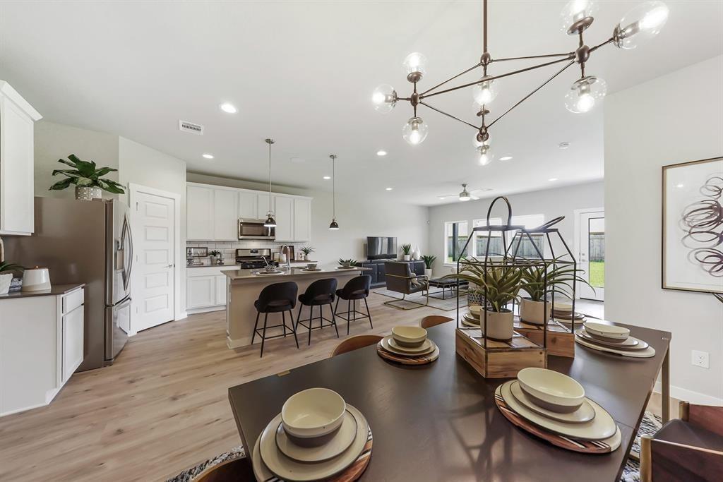 a kitchen with sink table and chairs