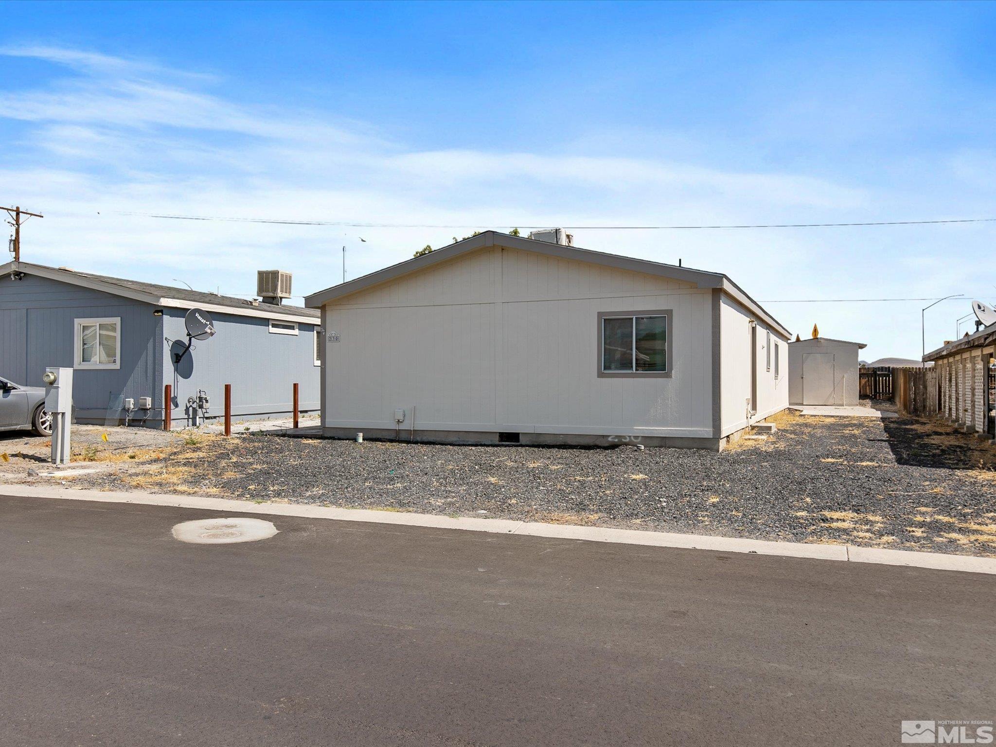 a view of a house with backyard space and a parking lot