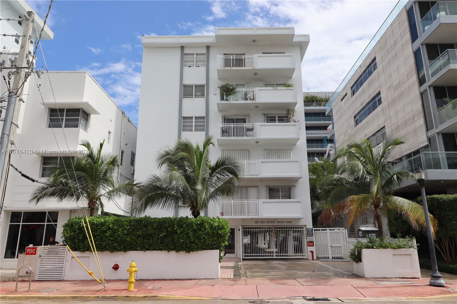 a front view of a building with palm tree