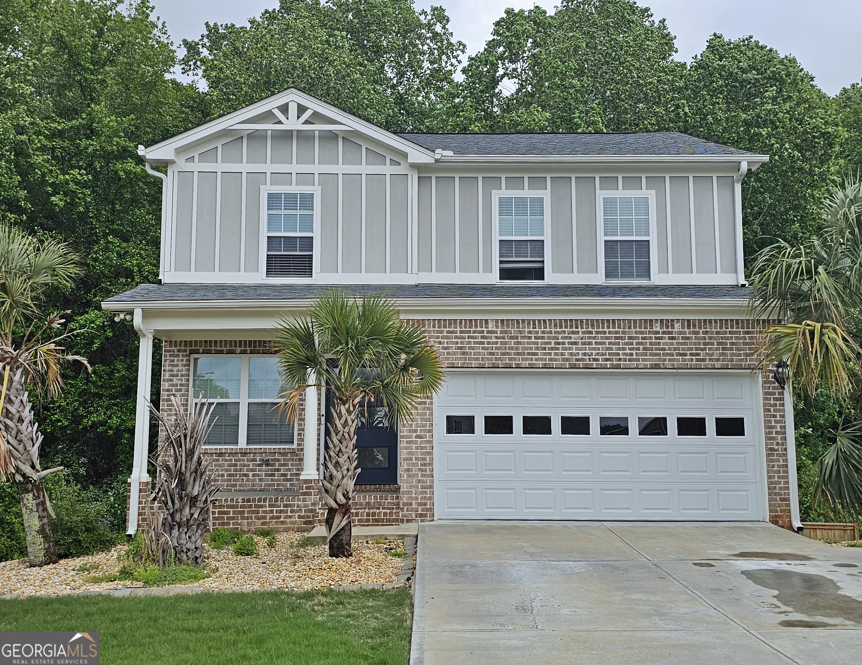 a front view of a house with a yard