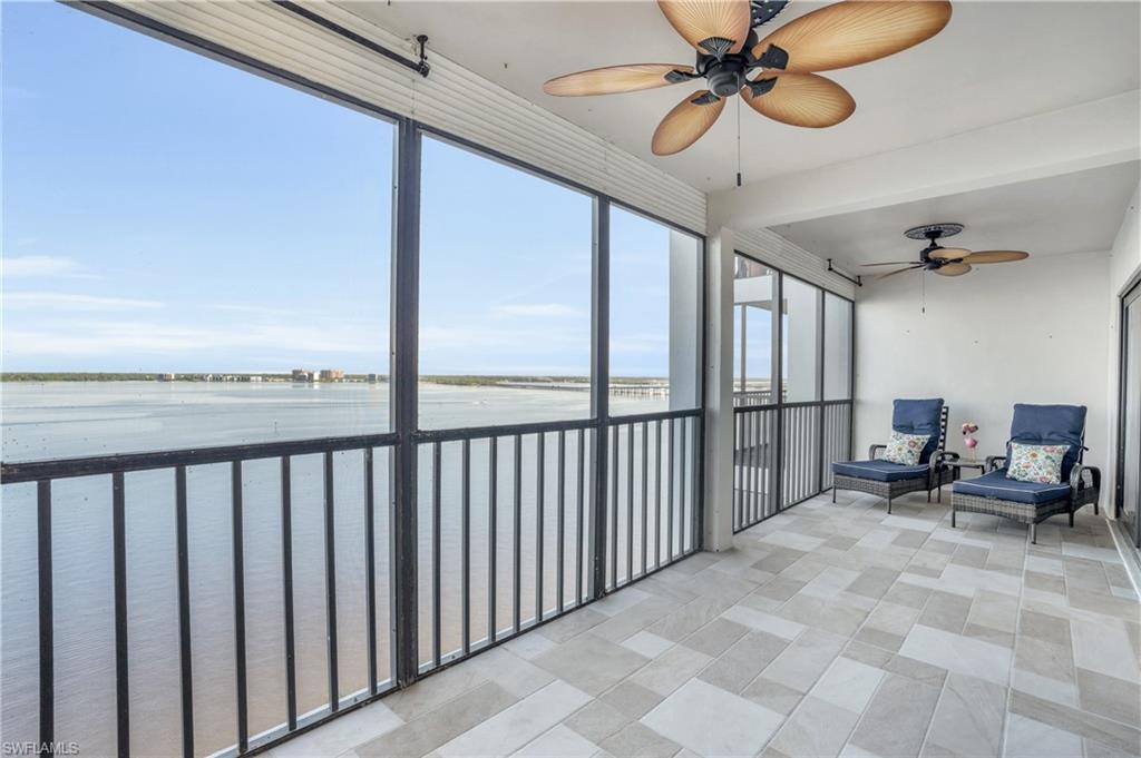 Sunroom featuring a water view and ceiling fan