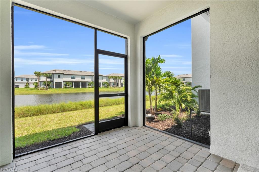 Unfurnished sunroom featuring a water view