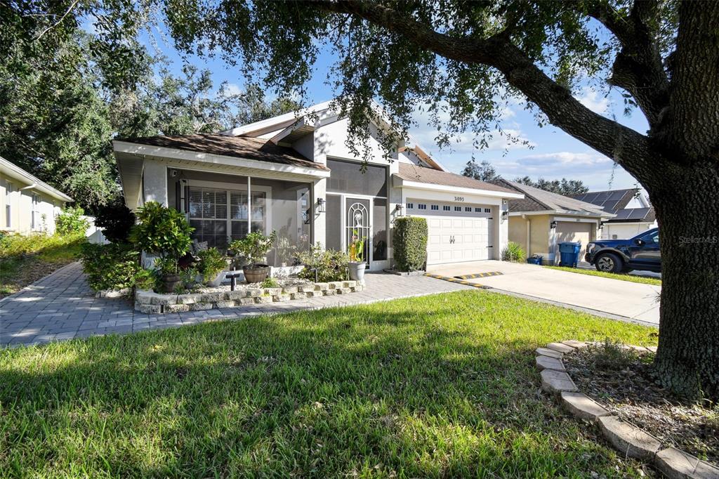 a view of house with outdoor seating and yard