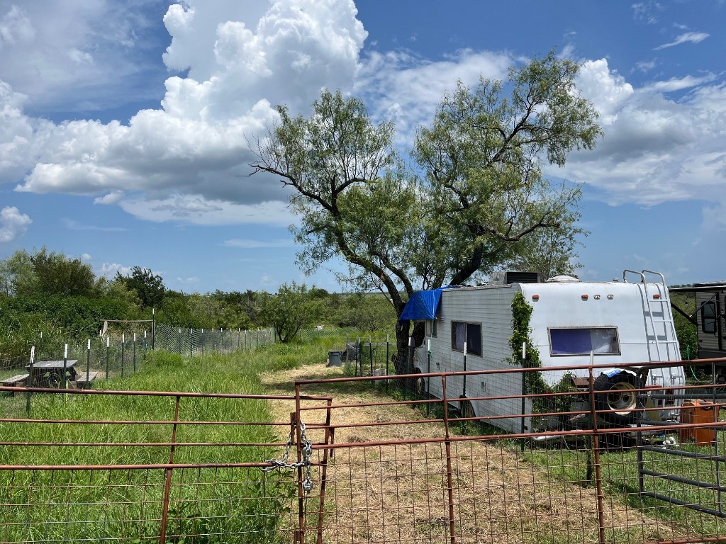 a view of house with yard and car parked