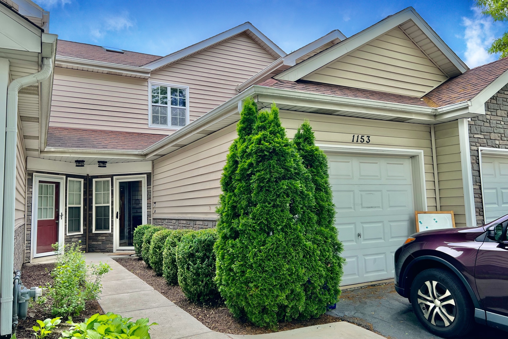 a front view of a house with garden