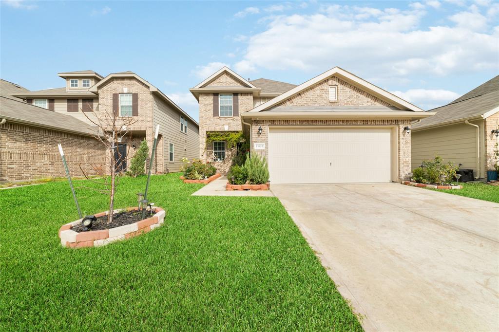 a front view of a house with a yard and garage