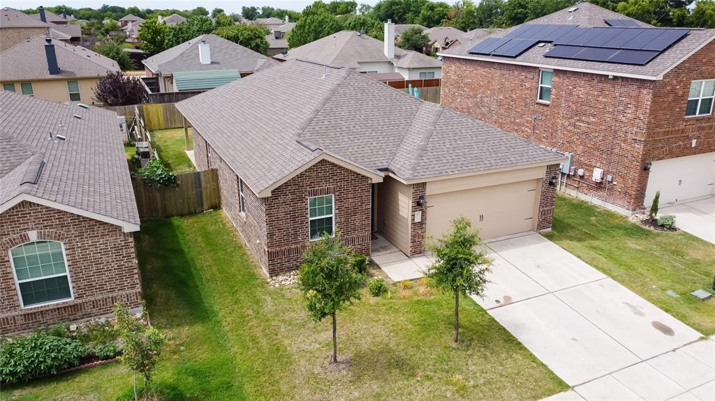 an aerial view of a house with a yard