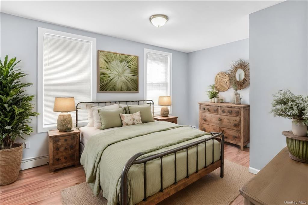 a bedroom with a bed a dresser and potted plants