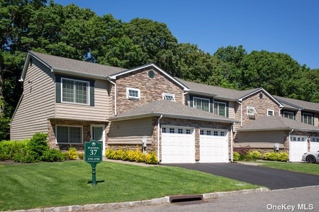 a front view of a house with a garden and yard