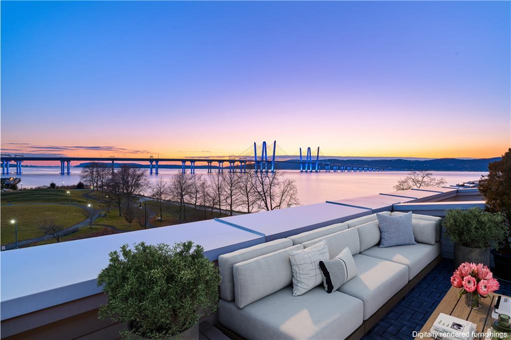 a view of a terrace with couches and city view