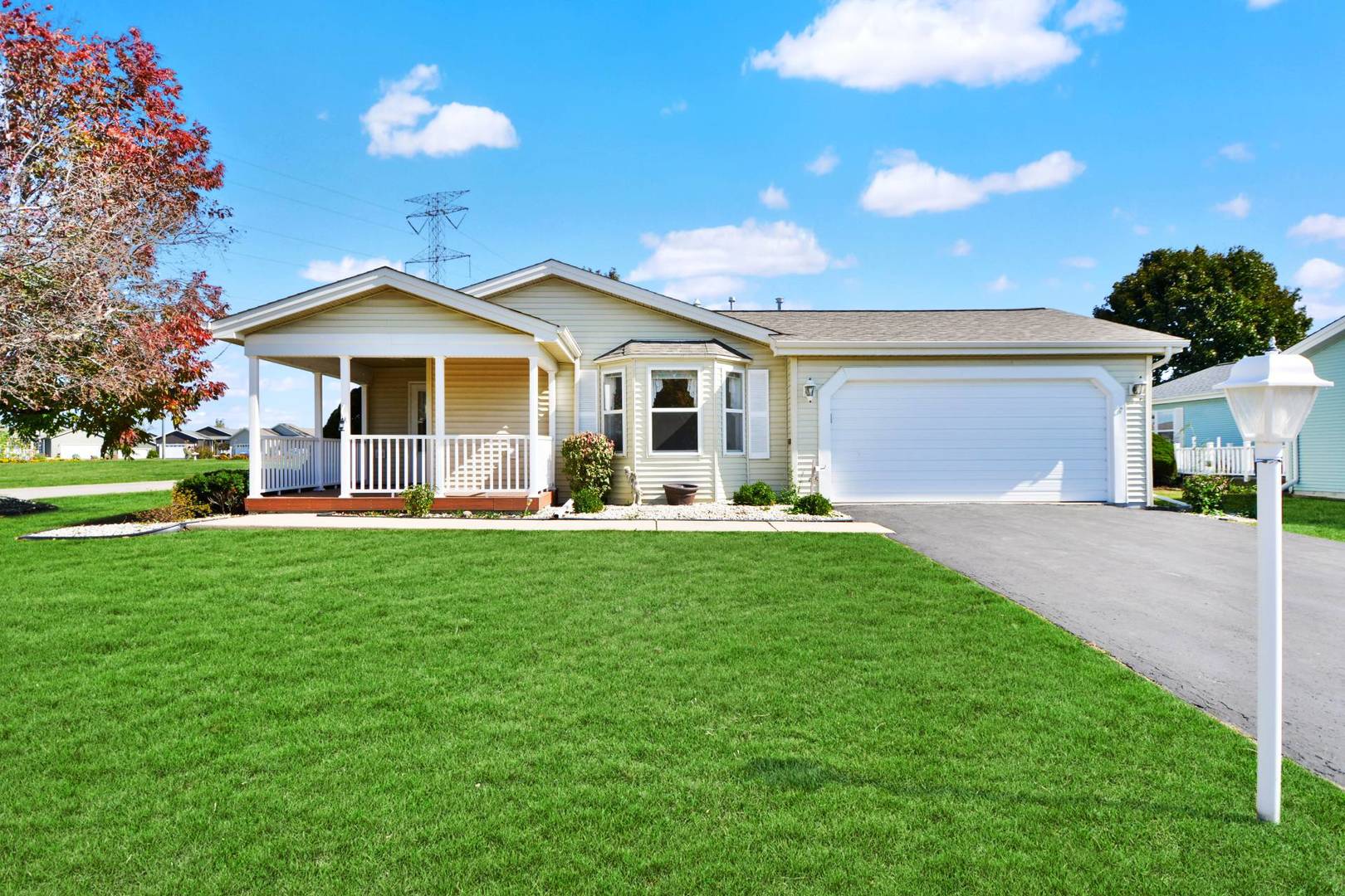 a front view of a house with a garden and yard