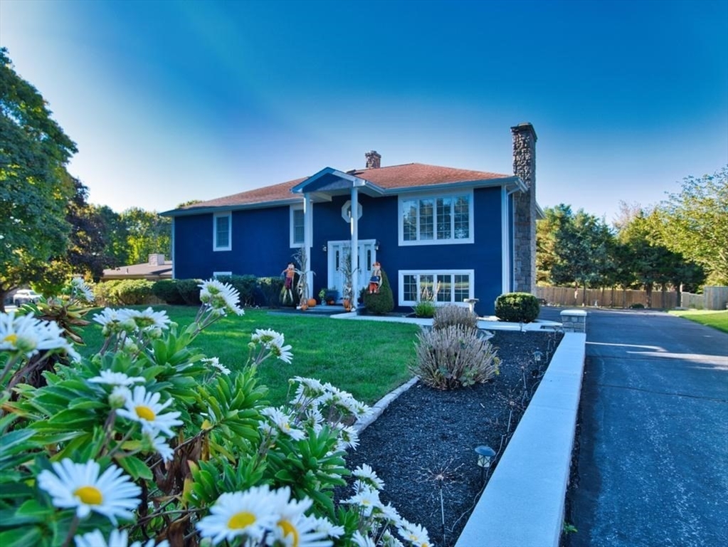 a front view of a house with garden