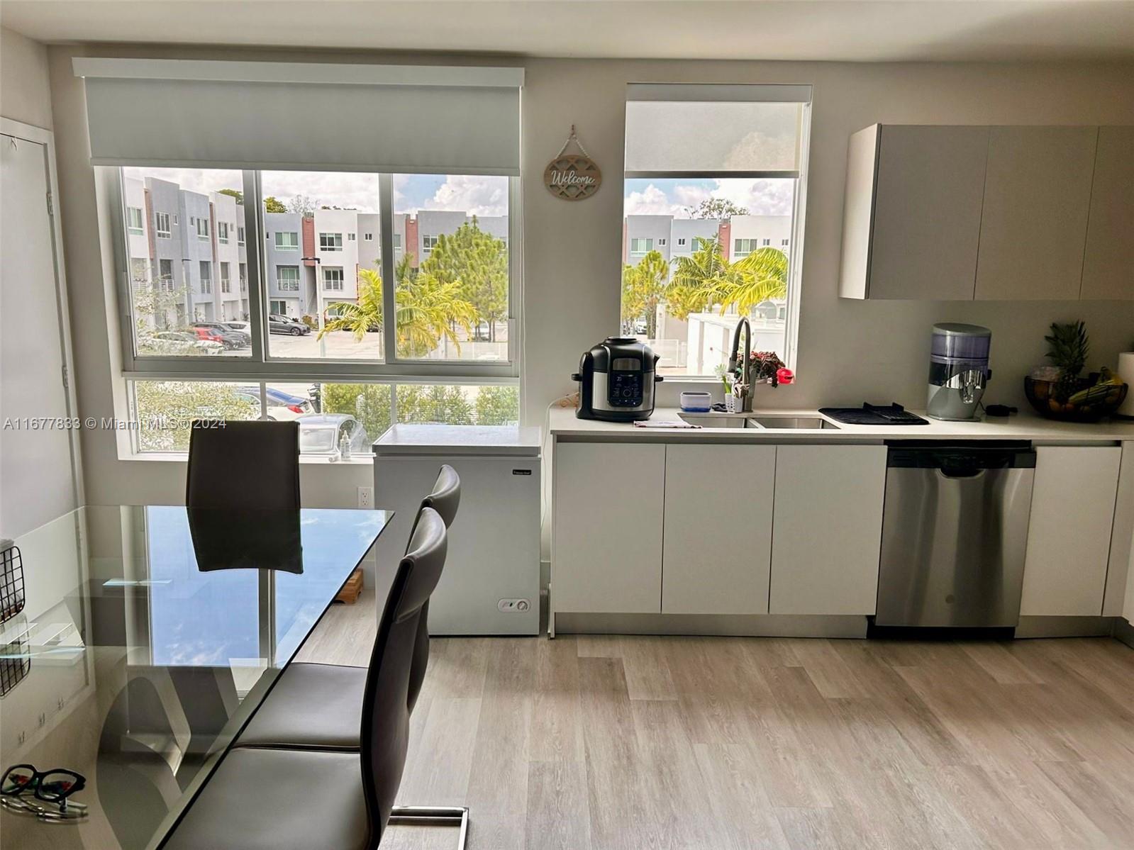 a kitchen with stainless steel appliances a stove a sink dishwasher and a refrigerator