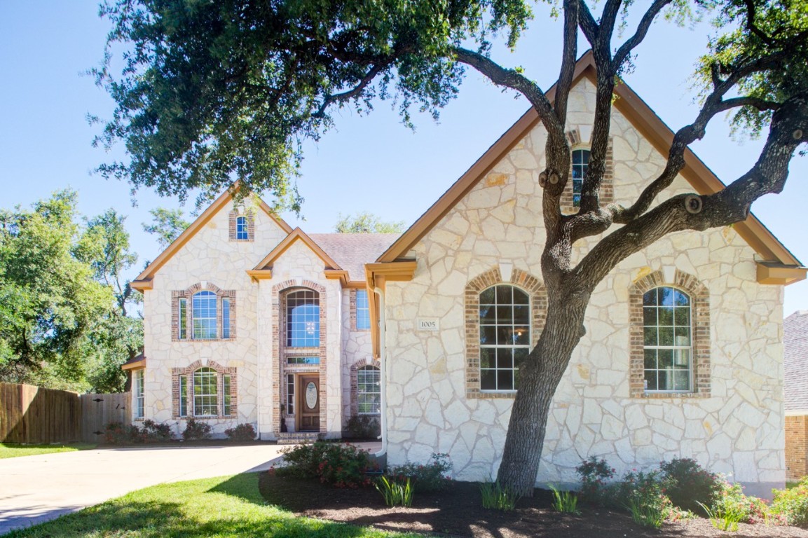 a front view of a house with garden