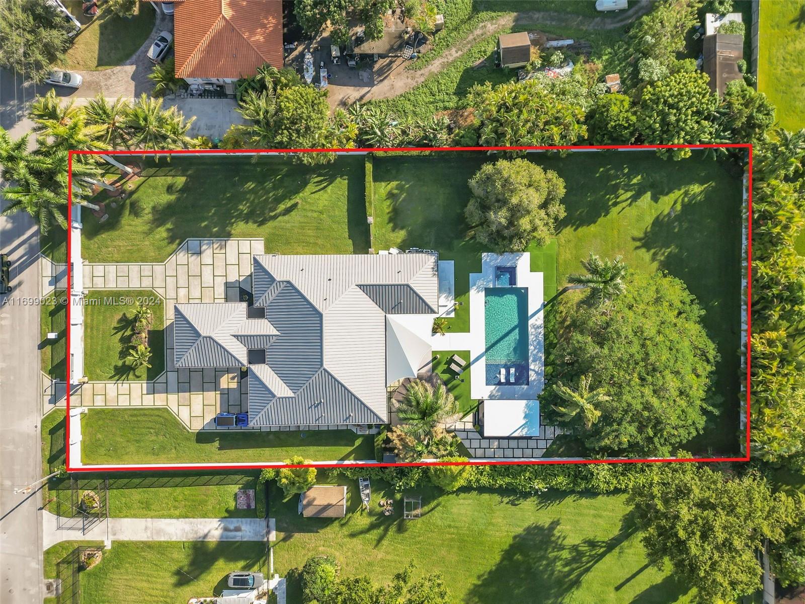 an aerial view of a house with a garden and lake view