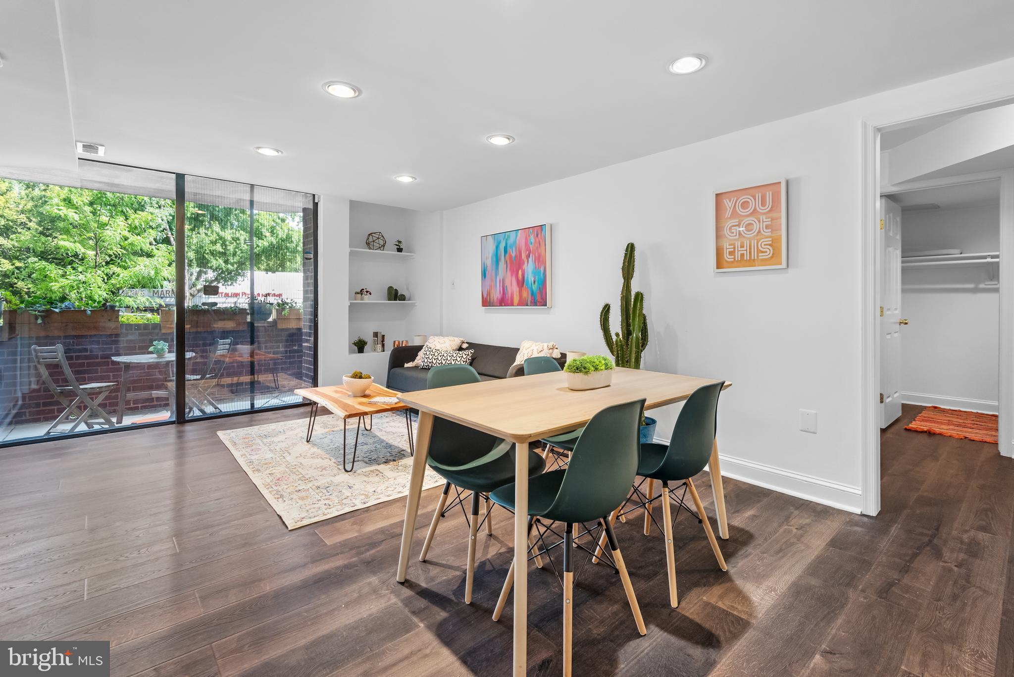 a view of a dining room with furniture wooden floor and a window