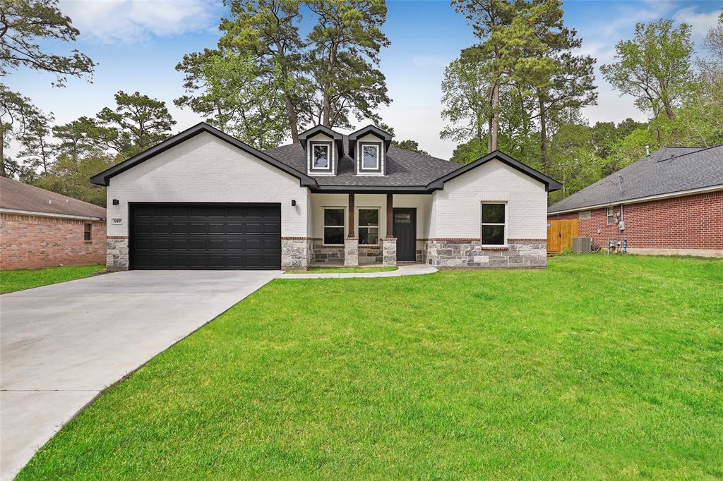 a front view of a house with a garden and yard