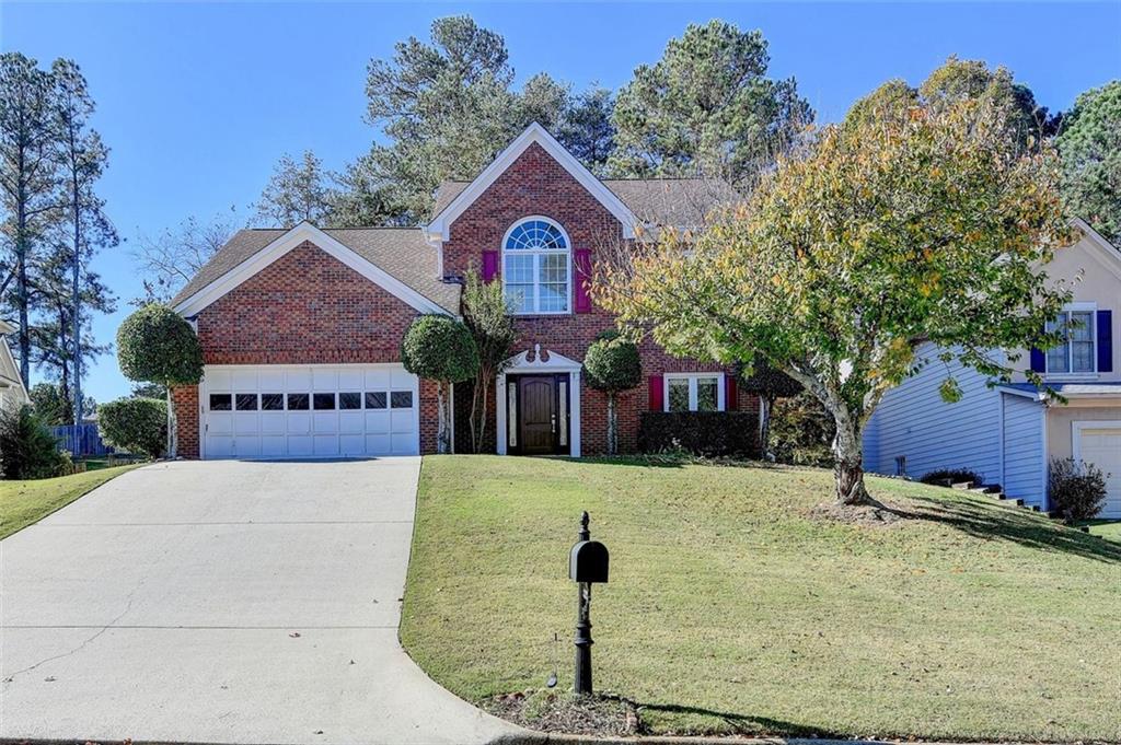 a front view of a house with a yard