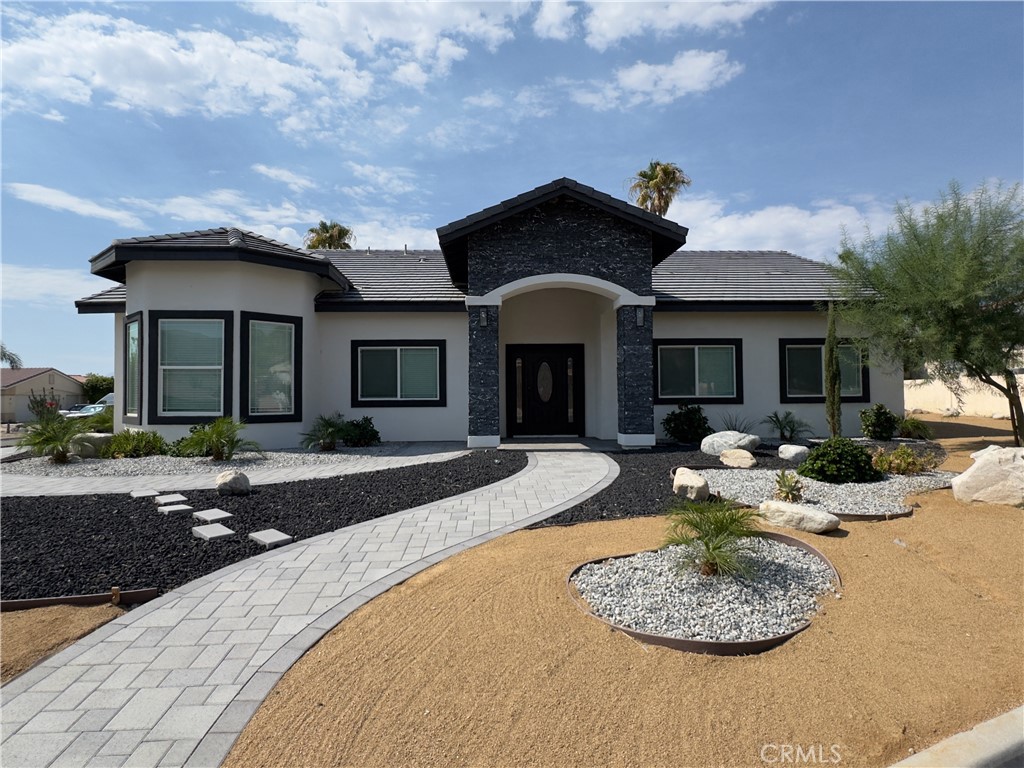 a front view of a house with swimming pool and porch