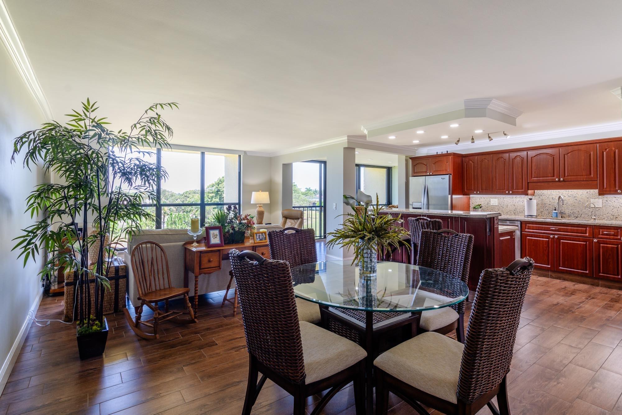 a dining room with furniture window and wooden floor