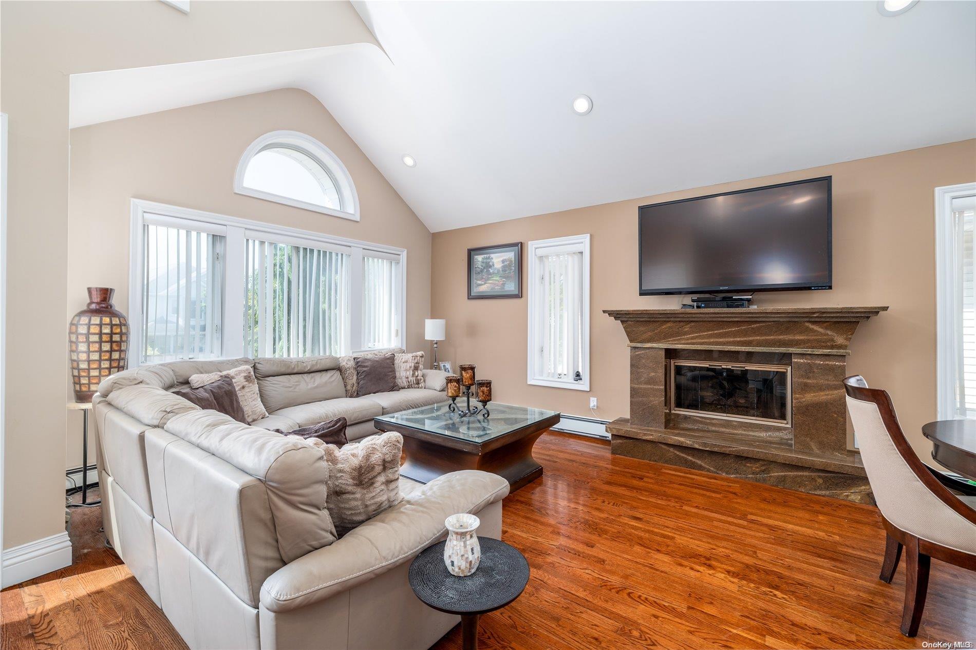 living room with granite fireplace