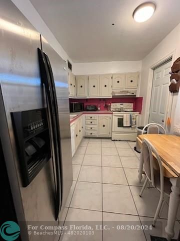 a washing machine sitting inside of a kitchen