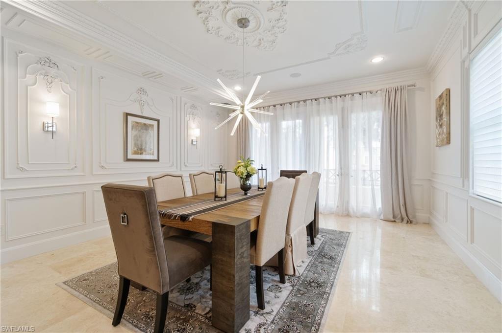 a view of a dining room with furniture and a chandelier