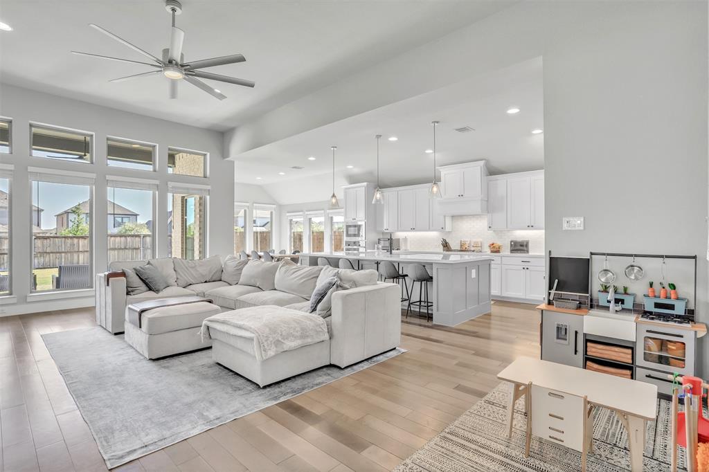 a living room with furniture and kitchen view