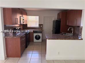 a kitchen with a stove top oven sink and cabinets