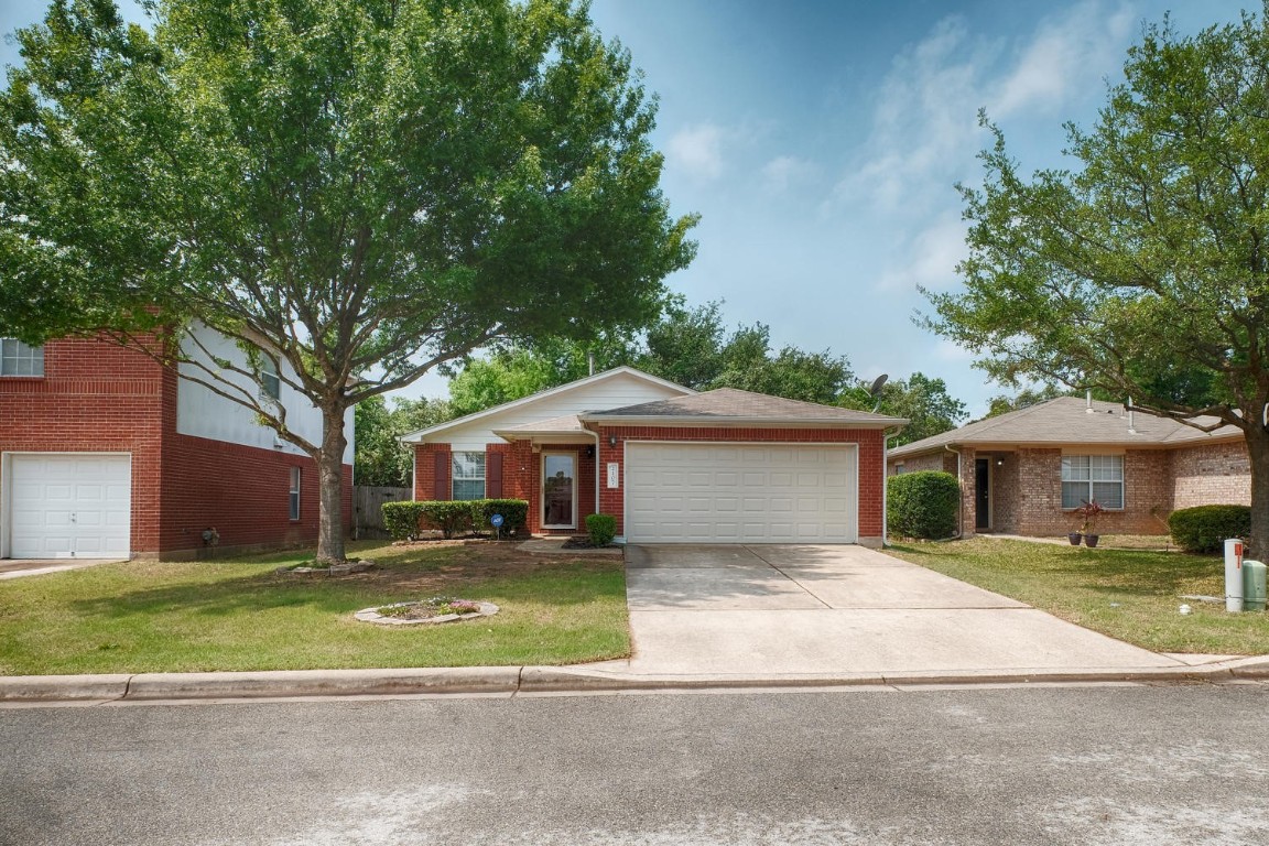 The outside of the home is very inviting with mature trees and a large driveway that allows for plenty of parking.