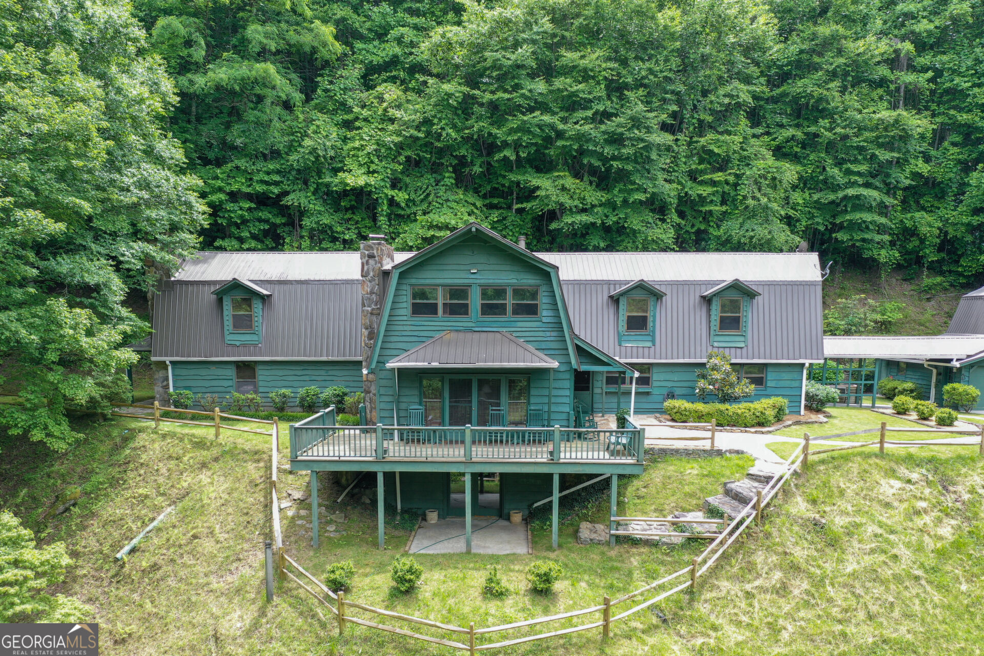 a view of house with swimming pool and outdoor seating