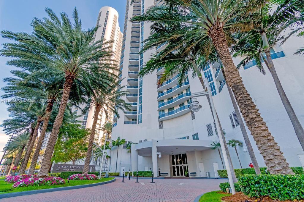 a front view of a multi story building with yard