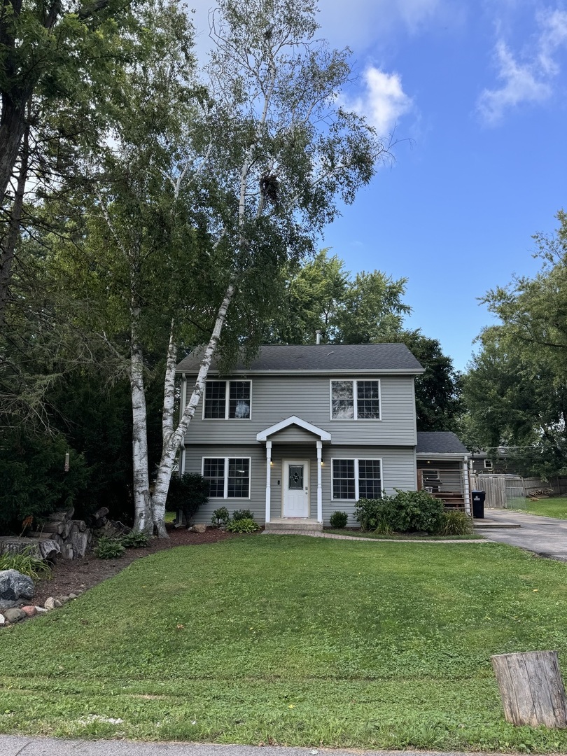 a front view of a house with a yard