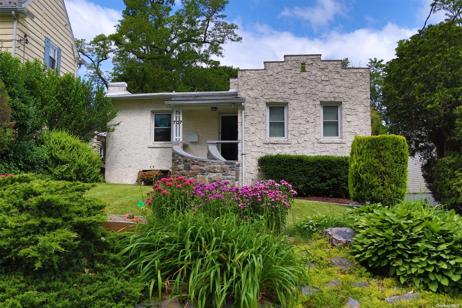 a view of a house with a yard and garden