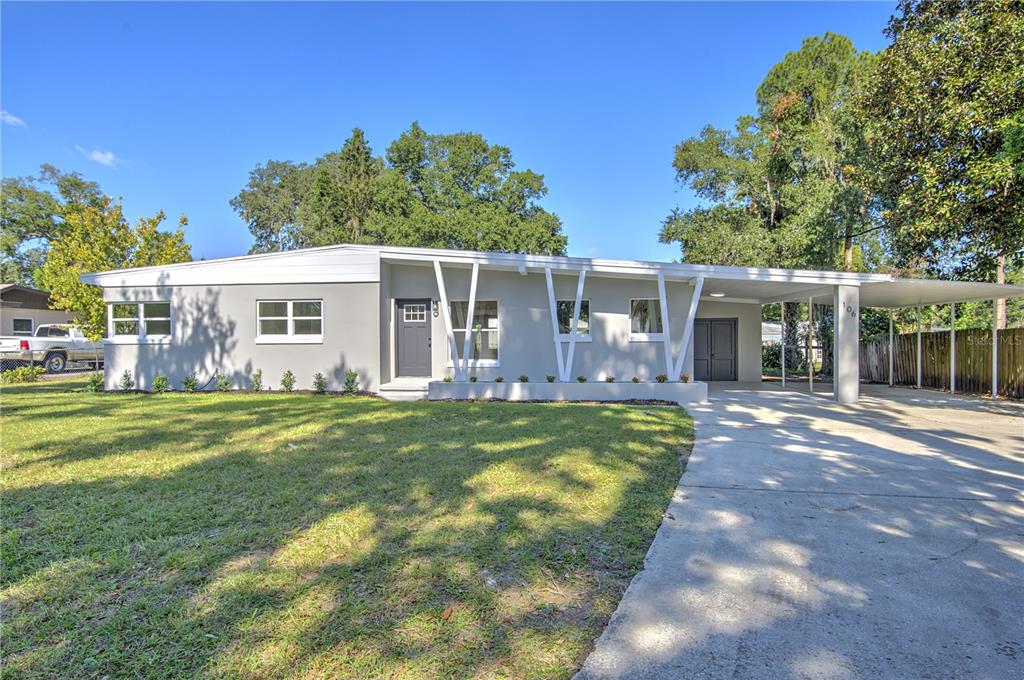 a view of a house with a yard patio and swimming pool