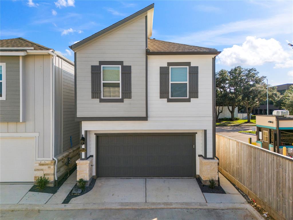 a front view of a house with garage