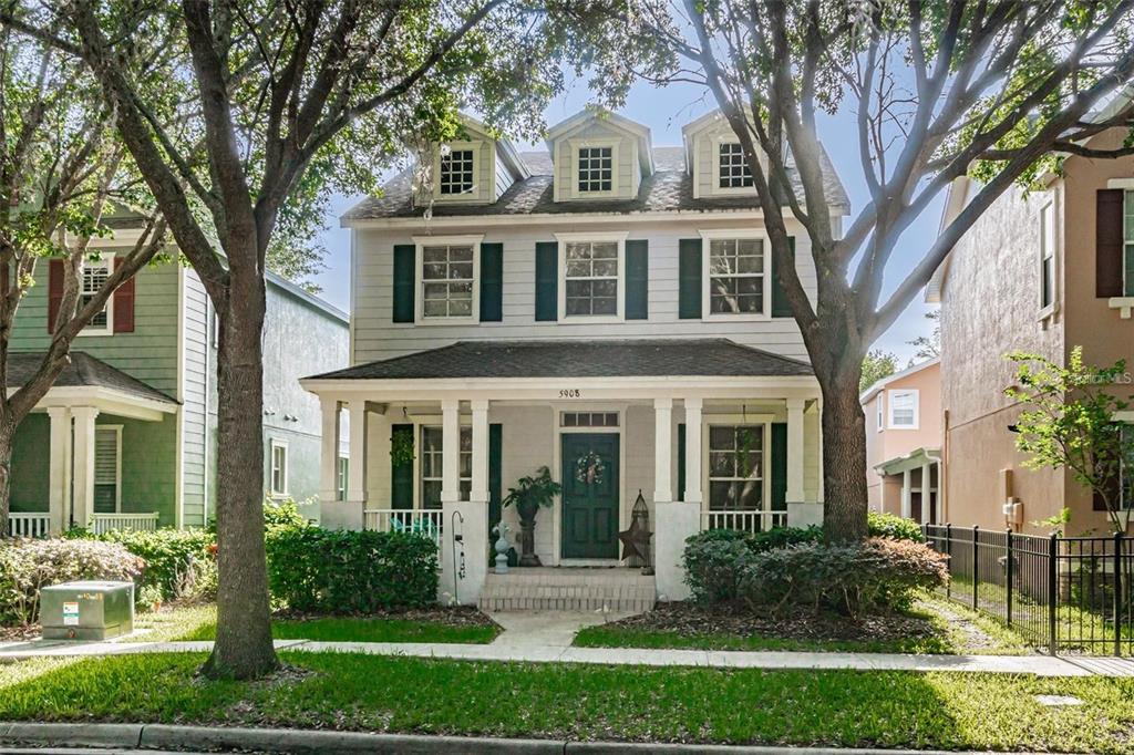 a front view of a house with yard and green space