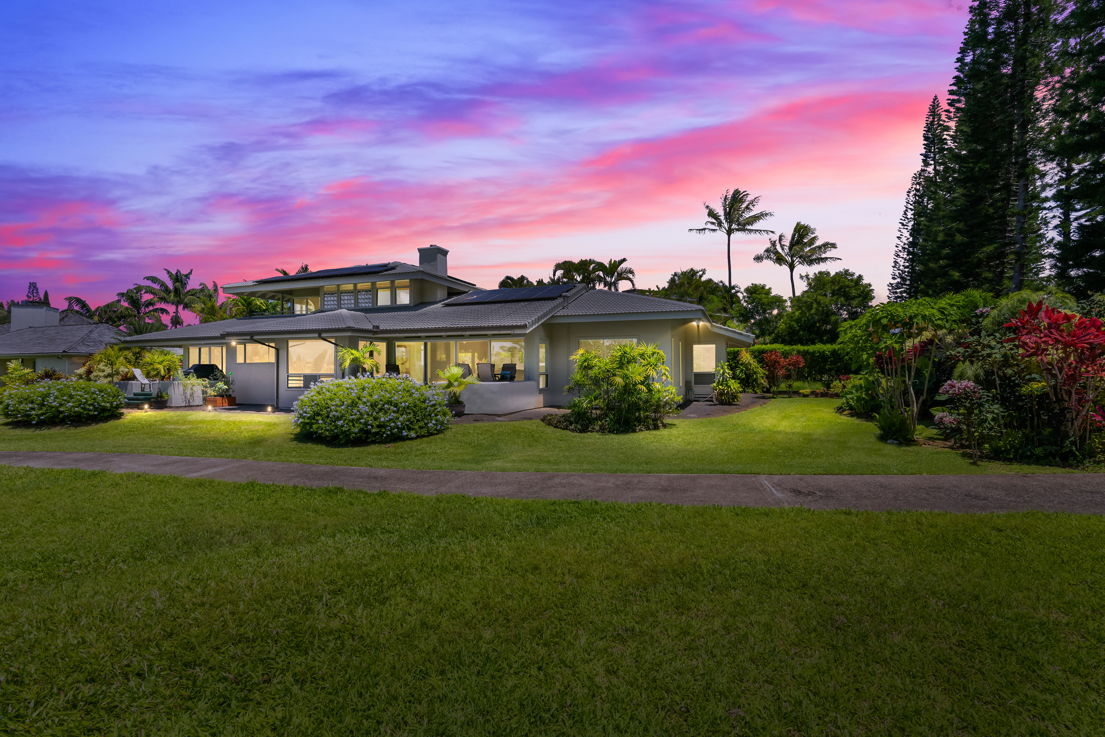 a front view of a house with a garden