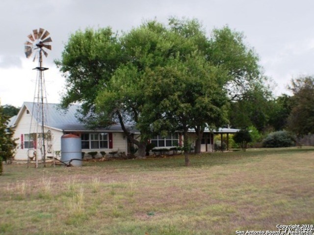 a view of a house with a backyard