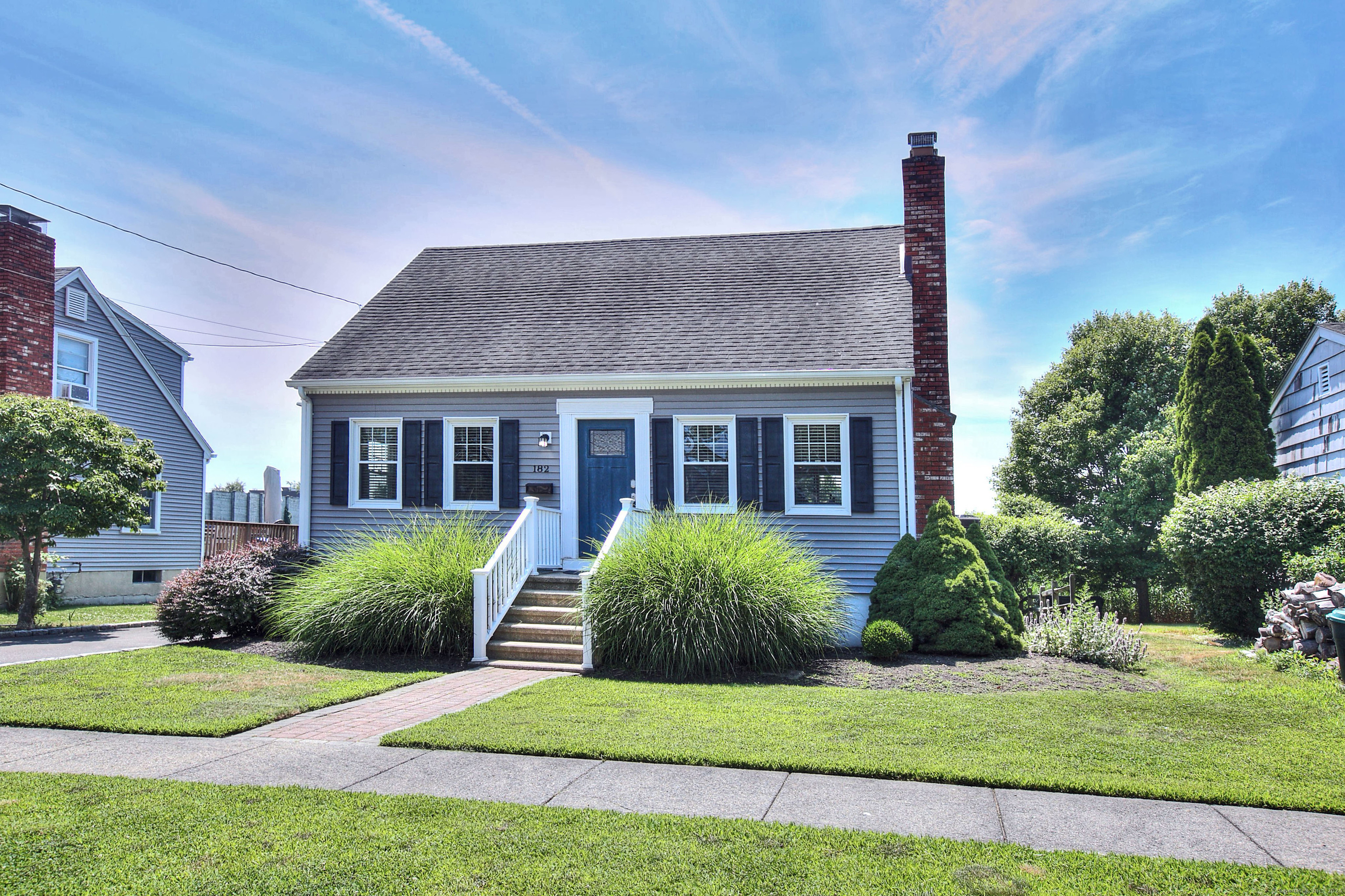 a front view of a house with garden