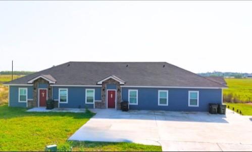 a front view of a house with yard and garage