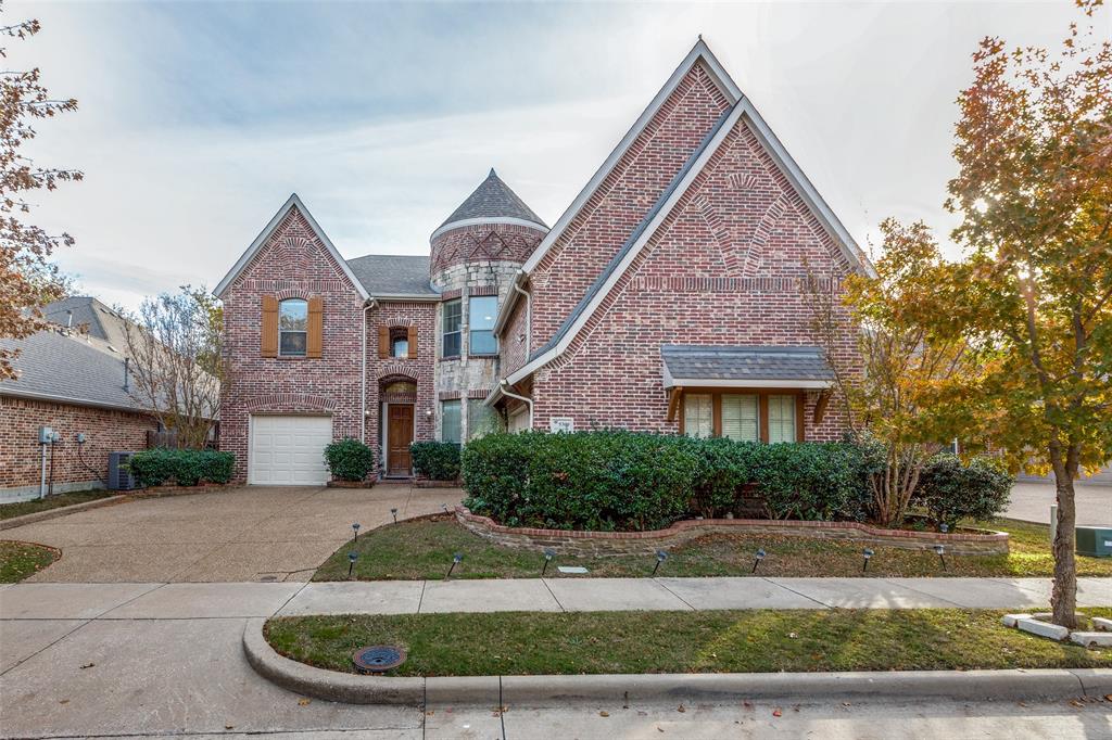 a view of a brick house next to a yard